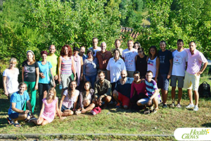 A group photo of the participants and organisers at the 'Health Glows Weekend', July 2015 in Kosmaj, Serbia. At the 'Health Glows Weekend', guests learn in theory and practice how to eat a raw vegan diet, exercise daily and maintain a high level of health long-term through a healthy lifestyle.
