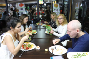 Guests enjoying a raw vegan dinner at the 'Adriatic Fruit Festival', October 2022 in Ulcinj, Montenegro. At the 'Serbian Fruit Festival', guests learn in theory and practice how to eat a raw vegan diet, exercise daily and maintain a high level of health long-term through a healthy lifestyle.