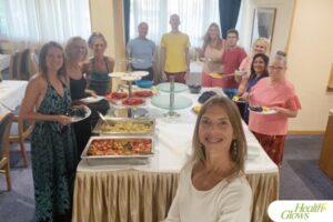 A group of participants of the 'Serbian Fruit Festival' 2024 gathered around a table at which a raw vegan lunch was served.