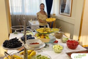 Marina from Health Glows is standing next to the dining table with a colourful spread of raw foods at the 'Serbian Fruit Festival' 2024.