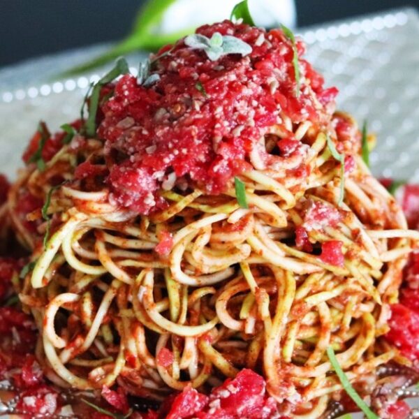 Raw vegan spaghetti marinara pasta on a plate.