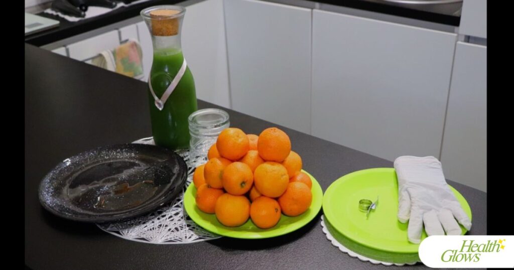 Ingredients and equipment for preparing a raw vegan breakfast: clementines and green juice.