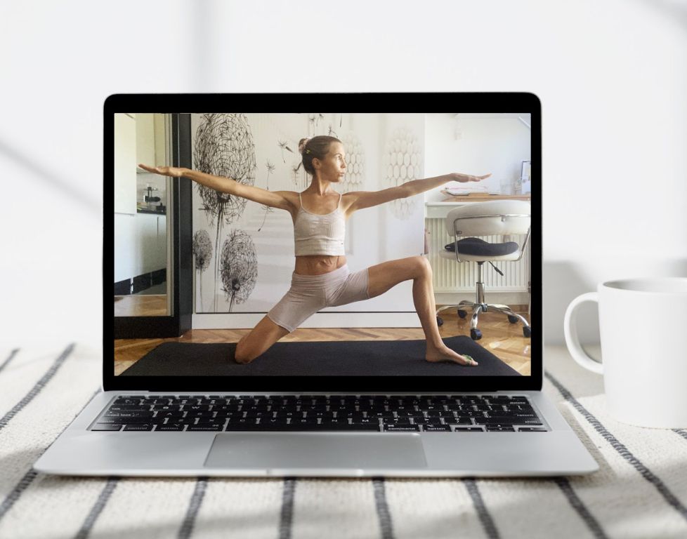 Marina from Health Glows demonstrates the 'Kneeling Warrior II' yoga pose ('Eka Janu Bhumi Virabhadrasana') on a laptop screen.