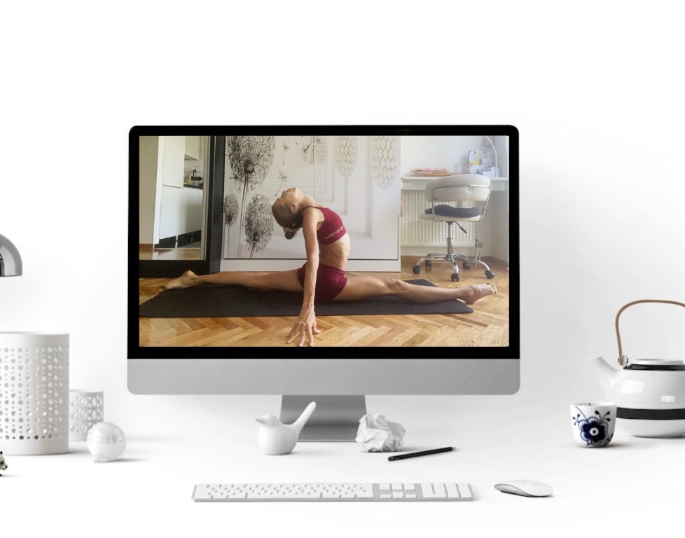 Marina from Health Glows demonstrates the 'Splits' yoga pose ('Hanumanasana') on a laptop screen.