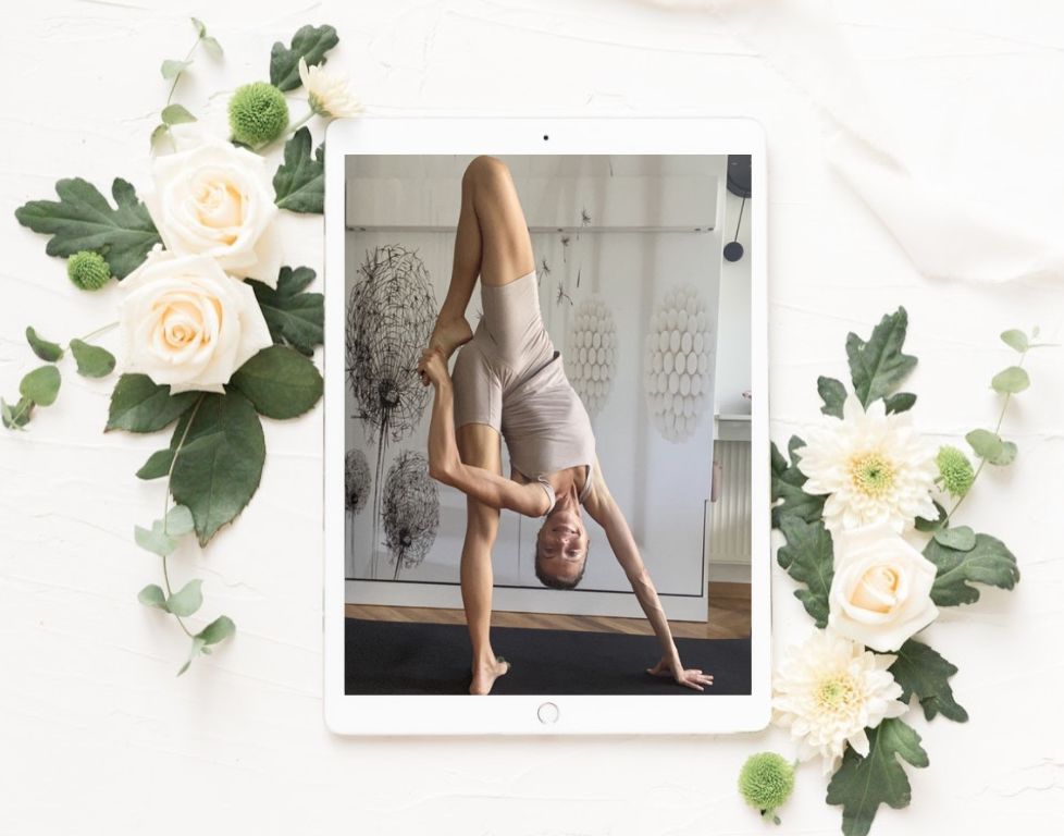 Marina from Health Glows demonstrates the 'Super Soldier' yoga pose ('Viparita Parivrtta Surya Yantrasana') on a tablet screen.